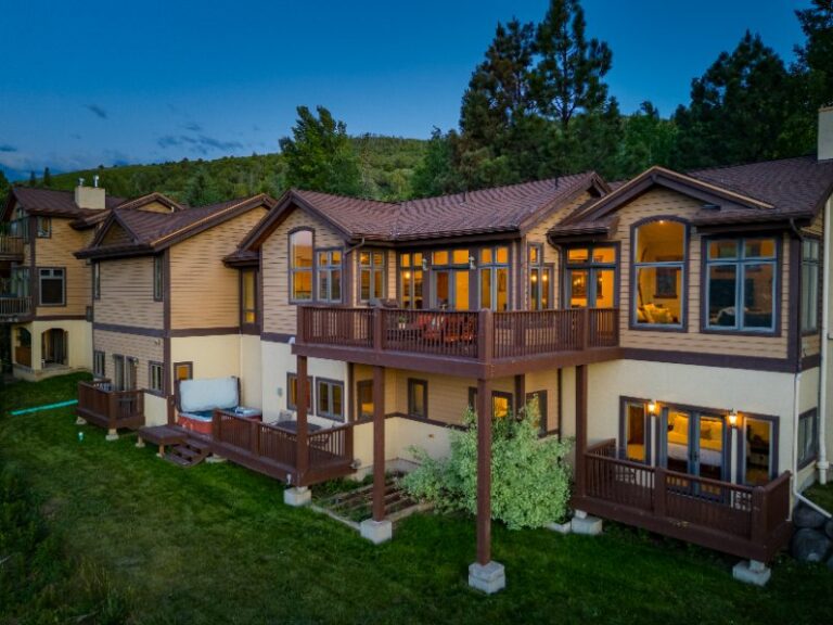 Back of the duplex at 626 Gold Dust Drive in Edwards at dusk, with decks and a hot tub